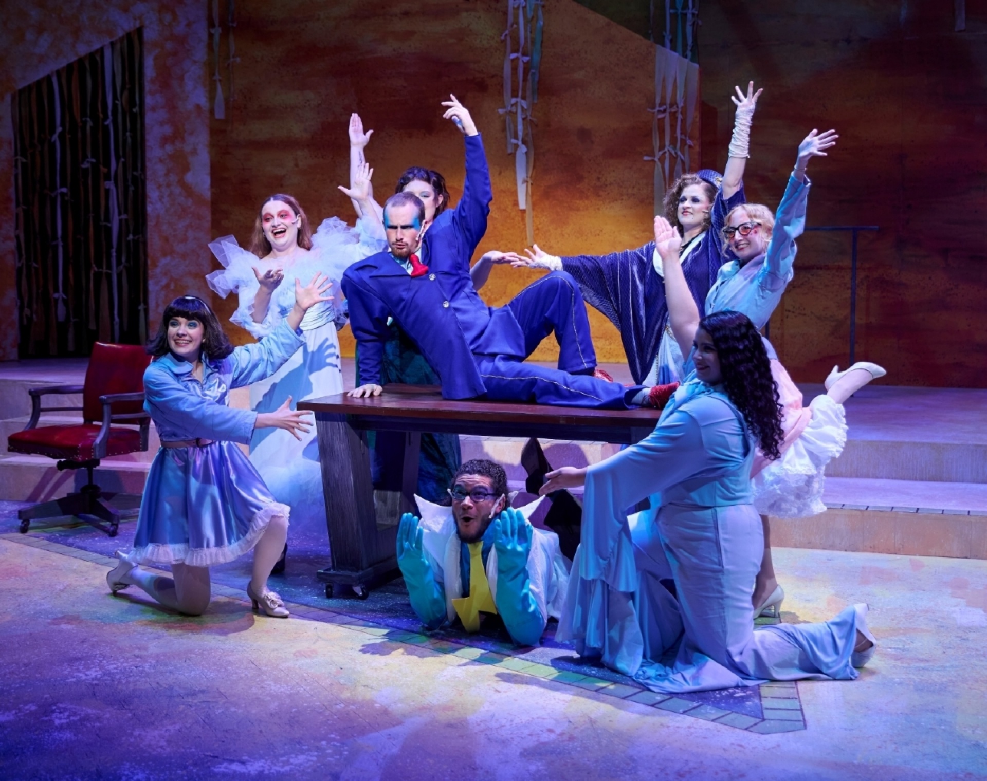 Students on stage with lights on. 