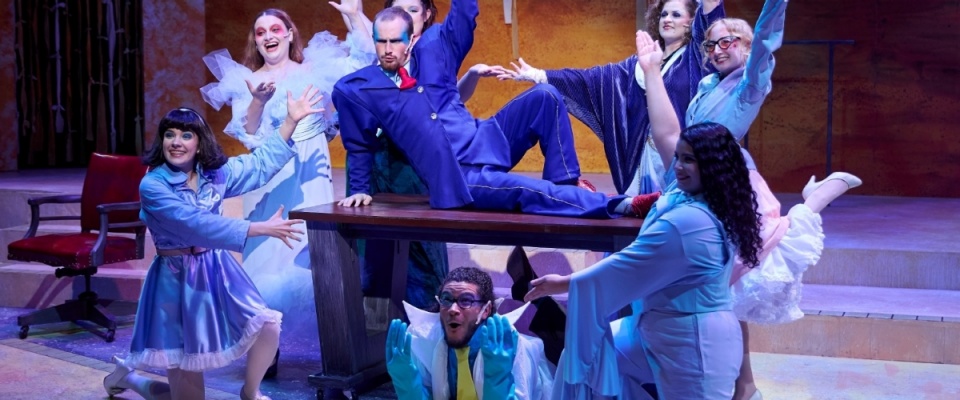 Students on stage with lights on. 