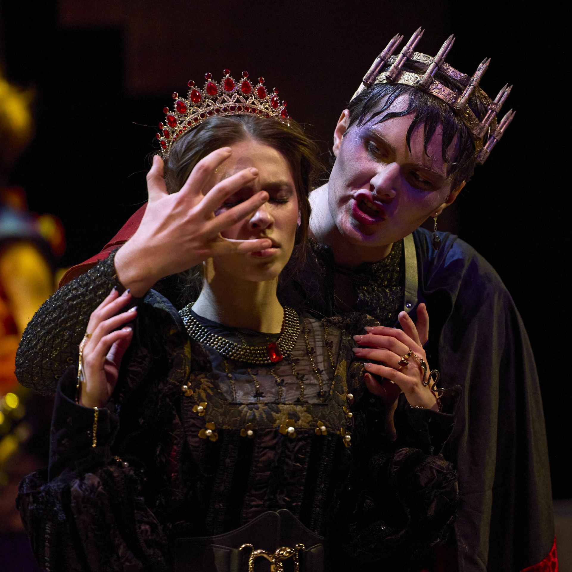 dancers on stage in sunglasses and dark striped bodysuits. 