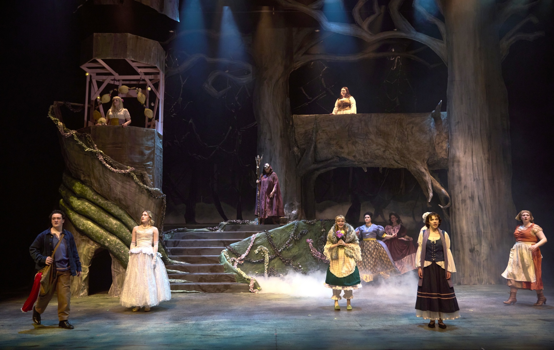 performers onstage - large set with trees and stairways for "Into the Woods". 