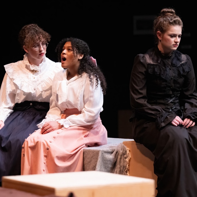 women performers on stage. 