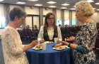 Department administrator Judy Edmister, alumna and commencement speaker Jaycee Miller, and associate professor of French Maureen Jameson enjoy a chat and hors d'oeuvres.