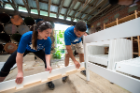 At the Service Collaborative, a team of Social Impact Fellows developed a plan to sustain its Beds for Buffalo initiative—and got their hands dirty helping the nonprofit construct beds too. Photo: Onion Studio.