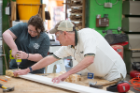 From left, Macy McDonald, a doctoral student in English, and Tom Ulbrich, assistant dean for social innovation and entrepreneurship initiatives, joined the entire cohort of fellows to help the Service Collaborative construct beds for children living in poverty. Photo: Onion Studio.