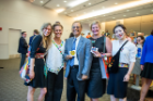 The winner of the Pitch for a Cause competition was the Stitch Buffalo team. From left, Kristie Bailey, MSW student; Dawne Hoeg, founder and director of Stitch Buffalo; Satish K. Tripathi, UB president; Shannon Lach, MBA student; and Xingyu Chen, doctoral student in global gender studies, show off a few of Stitch Buffalo's products. Photo: Onion Studio.