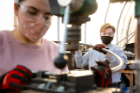 UB students use a drill press to work on stainless steel viper tubing, from which the structure was constructed. Photo: Meredith Forrest Kulwicki