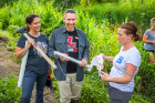 From left: Lancaster High School teachers Amy Balling and Christopher Riley talk with Kimberly Meehan, UB clinical assistant professor of geology, at the edge of Bizer Creek. Credit: Douglas Levere / University at Buffalo