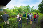 Kimberly Meehan (in white T-shirt and gray pants), UB clinical assistant professor of geology, speaks with teachers in the EarthEd Institute. The group journeyed to Bizer Creek on UB’s North Campus on July 12 to collect sediment cores, which they later analyzed in the lab. Credit: Douglas Levere / University at Buffalo