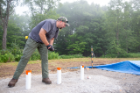 Andrew Harp, a recent UB geology PhD graduate, works on a blast pad. The white tubes mark locations where explosive charges will later be placed. Harp helped to organize the workshop. Photo: Meredith Forrest Kulwicki