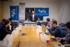 Jason Benedict, associate professor of chemistry, speaks to judges about the competition and how crystals should be rated. Photo: Douglas Levere