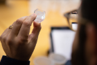 Luis Velarde, assistant professor of chemistry, served as one of the judges. Here, he inspects a crystal. Photo: Douglas Levere