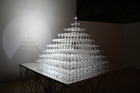 "Tide" is a pyramid of champagne glasses that gradually fill with water over the course of the exhibition, fed by a slow-dripping tube attached high above the uppermost glass. 