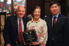 Nichols School Chinese language teacher Yajie Zhang receives the Confucius Educator Award at the farewell/awards dinner. Zhang is joined by Stephen Dunnett (left) and Zhiqiang Liu.