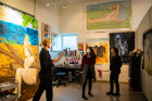 Anja Honisett (left) welcomes visitors to her studio. Honisett's work focuses on the evolution of the depiction of the female form throughout art history, including the transition to the digitization of the image and its manipulation.