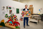In his studio space, Joseph Goergen shows one of his works. "…I love to talk to people and network, and having this event is another good way to connect and meet even more people,” he says.