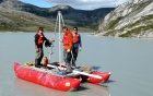 Three people standing on a boat. 