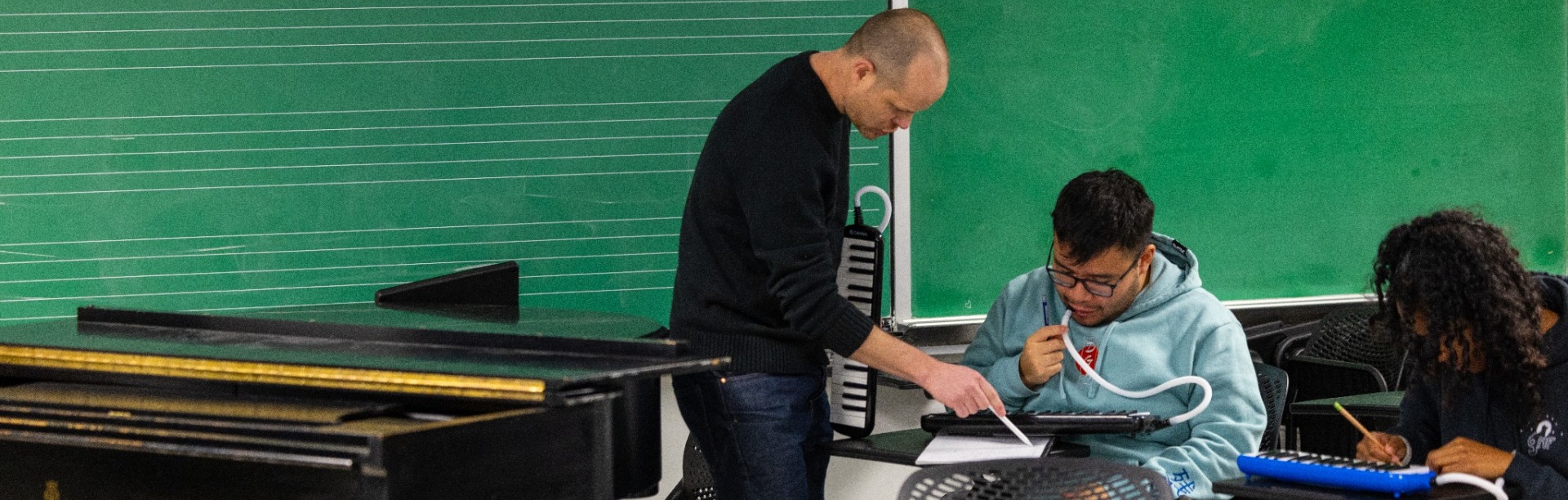 Brain Moseley helping a student at their desk.
